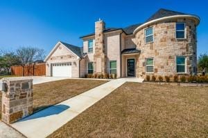 view of front of house featuring a garage and a front yard