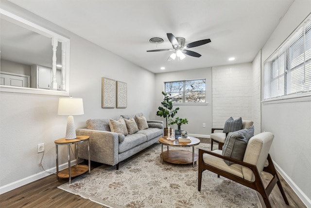 living room with hardwood / wood-style flooring and ceiling fan