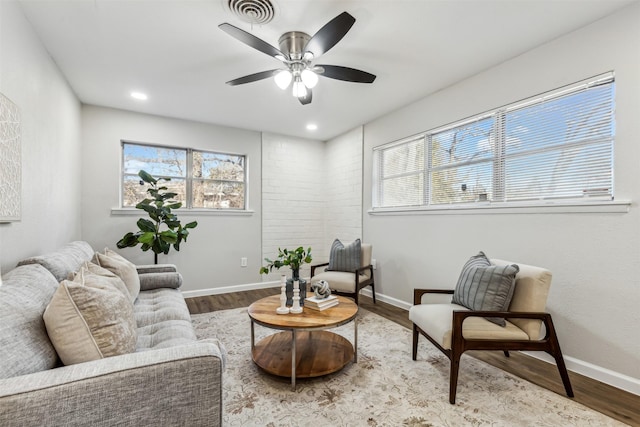 living room with hardwood / wood-style flooring and ceiling fan