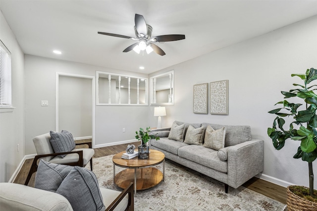 living room with hardwood / wood-style flooring and ceiling fan