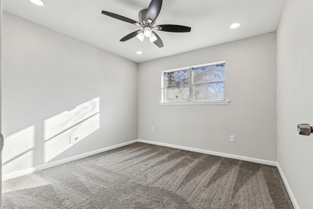 unfurnished room with ceiling fan and carpet