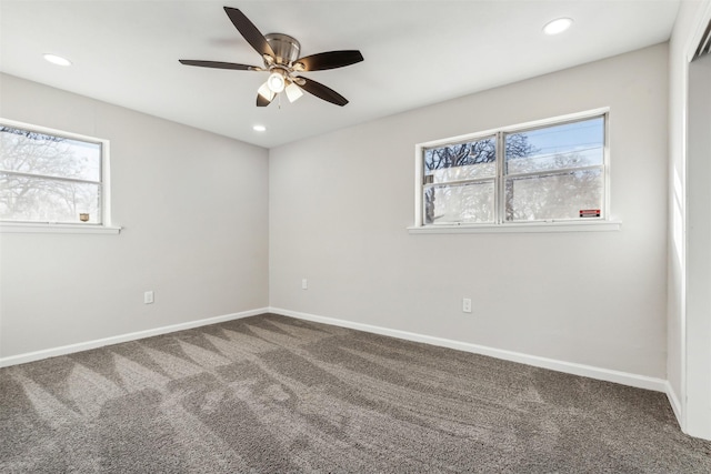 empty room featuring ceiling fan and carpet flooring