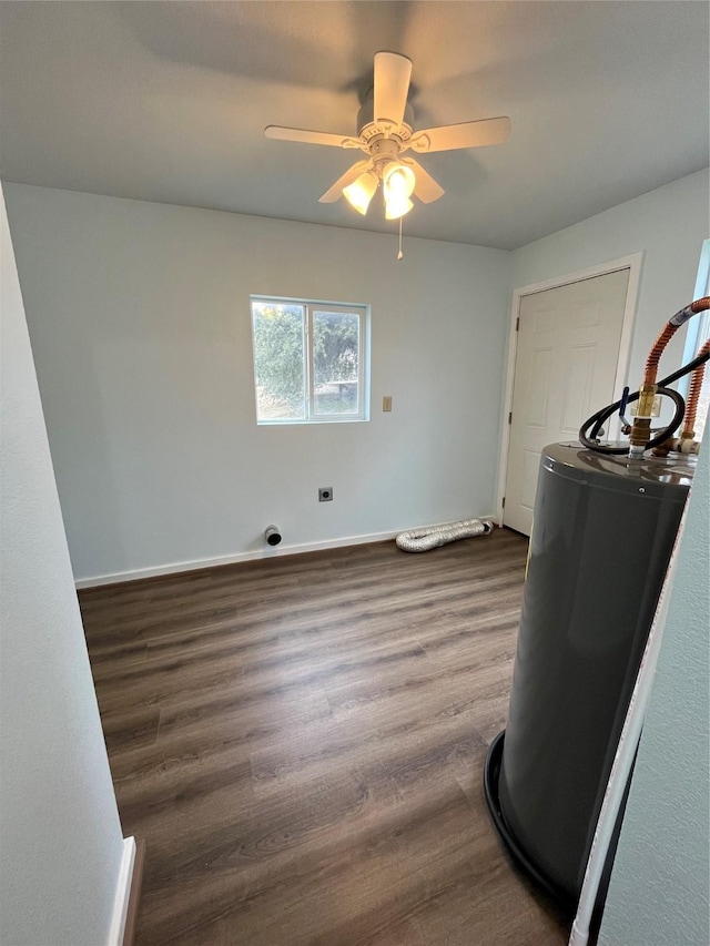 unfurnished room featuring a ceiling fan, baseboards, and dark wood-style flooring