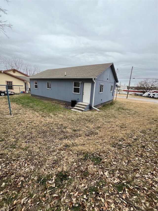 exterior space featuring a yard, entry steps, and fence