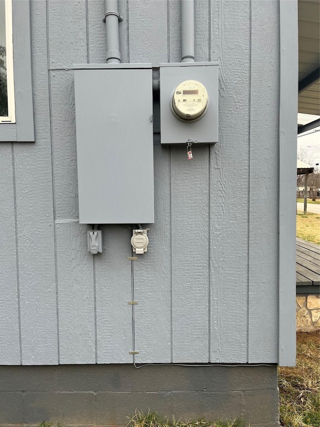 exterior details featuring electric meter and board and batten siding