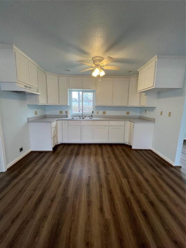 kitchen with dark hardwood / wood-style floors, white cabinetry, sink, ceiling fan, and a textured ceiling