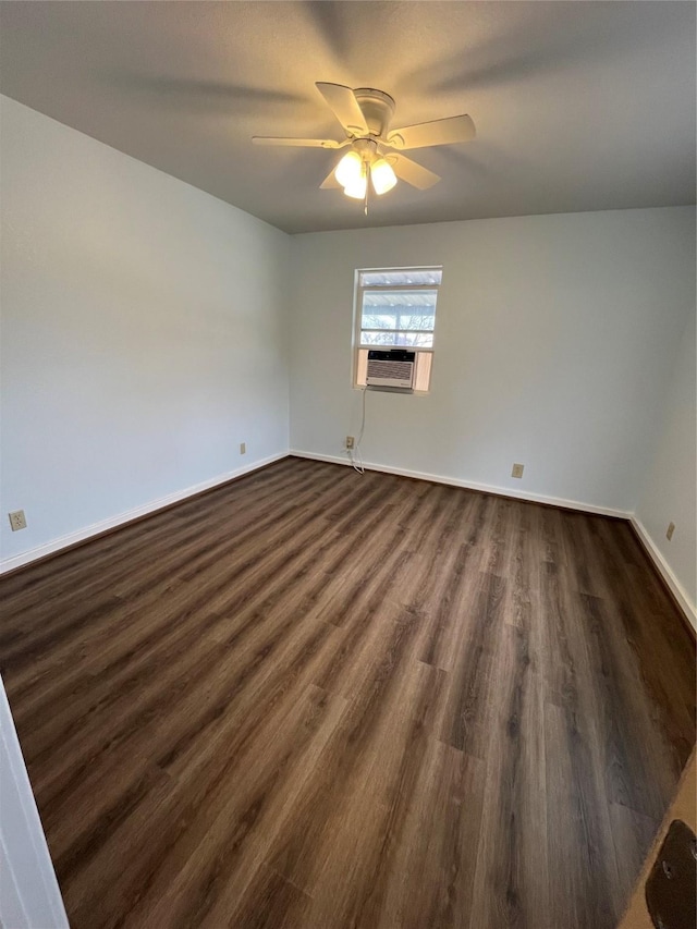 unfurnished room with baseboards, ceiling fan, cooling unit, and dark wood-style flooring