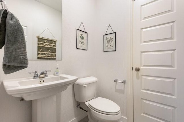 bathroom featuring sink and toilet