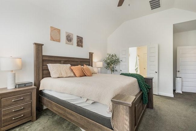 bedroom featuring dark colored carpet, lofted ceiling, connected bathroom, and ceiling fan