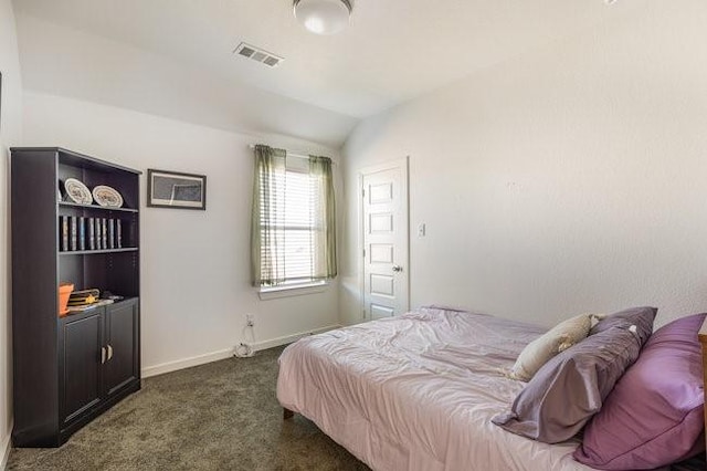 carpeted bedroom featuring lofted ceiling