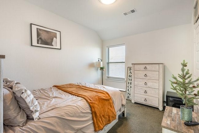 bedroom with dark carpet and vaulted ceiling