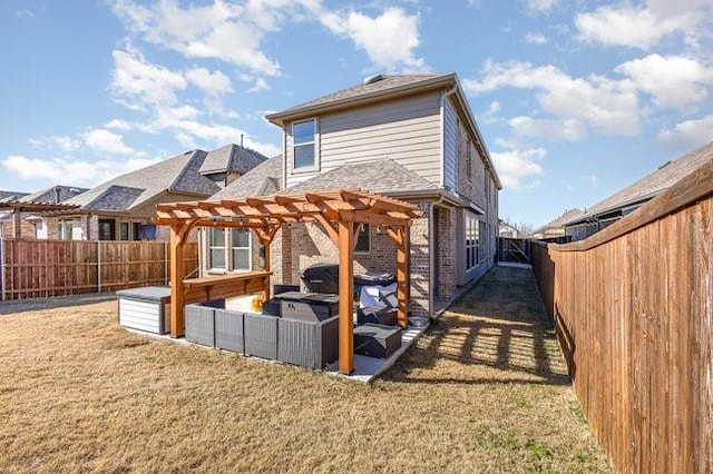 rear view of property featuring a pergola and a lawn