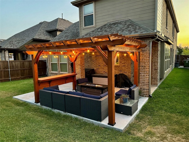 back house at dusk featuring a yard, a pergola, a patio area, and outdoor lounge area