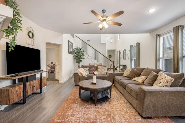 living room featuring hardwood / wood-style floors and ceiling fan