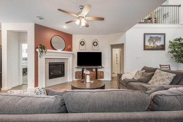 living room with hardwood / wood-style floors, a fireplace, and ceiling fan