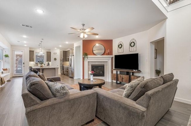 living room featuring hardwood / wood-style flooring and ceiling fan