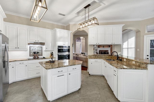 kitchen featuring pendant lighting, stainless steel fridge with ice dispenser, an island with sink, and white cabinets