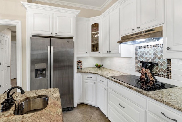 kitchen with white cabinets, sink, stainless steel fridge, and black electric cooktop