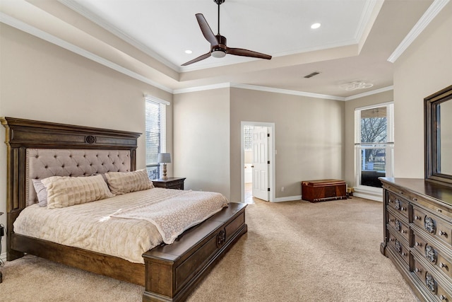 bedroom featuring a raised ceiling, light carpet, ceiling fan, and multiple windows