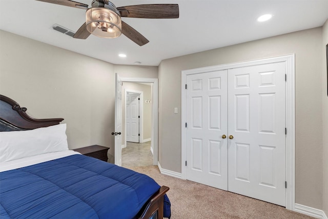 bedroom with light colored carpet, a closet, and ceiling fan