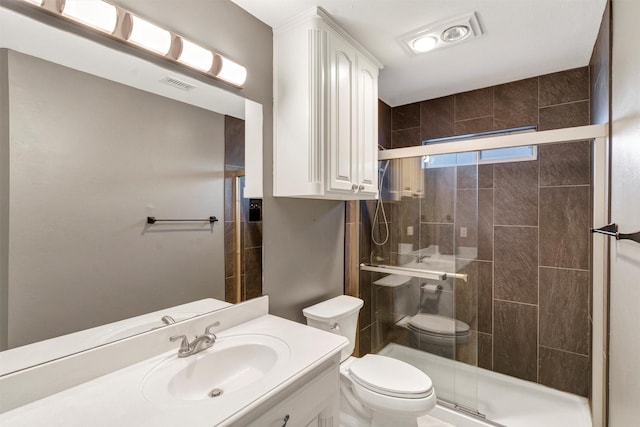 bathroom with vanity, a shower with shower door, and toilet