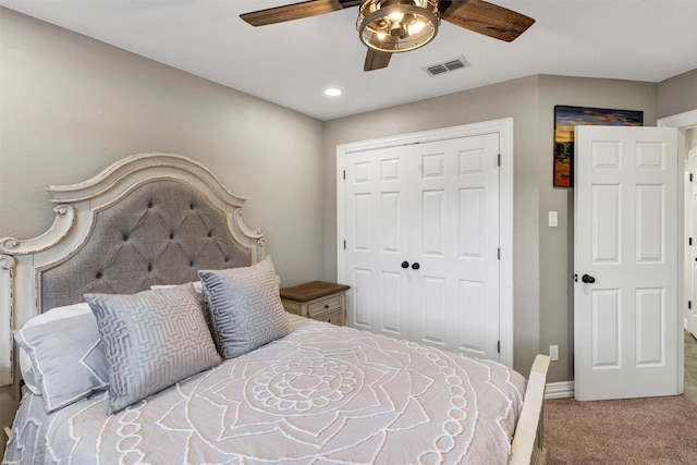 carpeted bedroom with ceiling fan and a closet