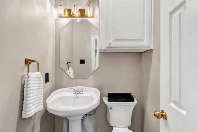 bathroom with toilet and sink