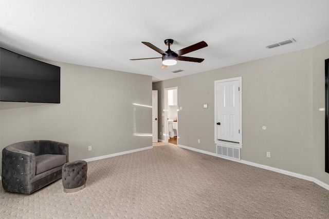 living area featuring carpet and ceiling fan