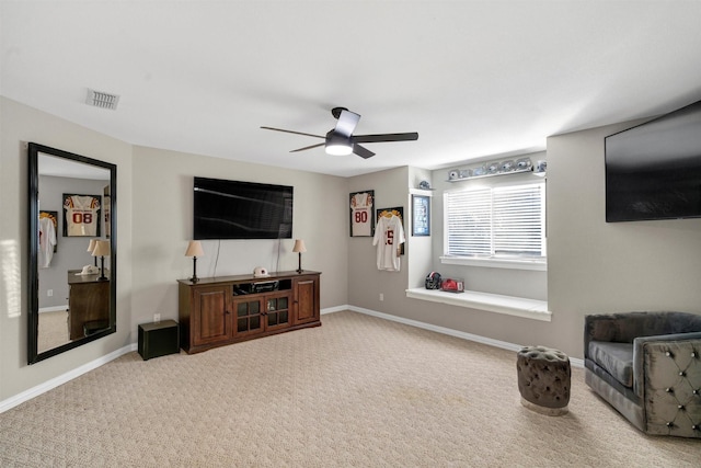 carpeted living room featuring ceiling fan