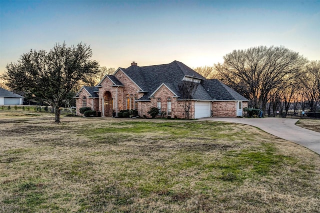 view of front of house with a yard and a garage