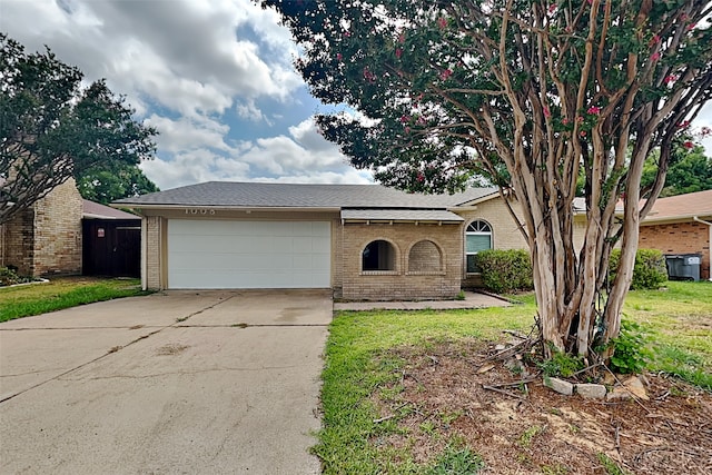 ranch-style home with a garage and a front yard