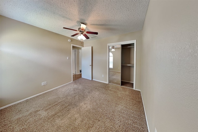 unfurnished bedroom featuring ceiling fan, carpet flooring, a closet, and a textured ceiling