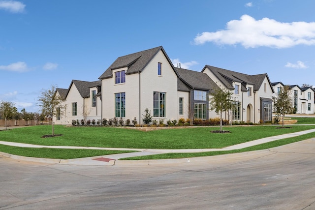 french provincial home featuring a front yard