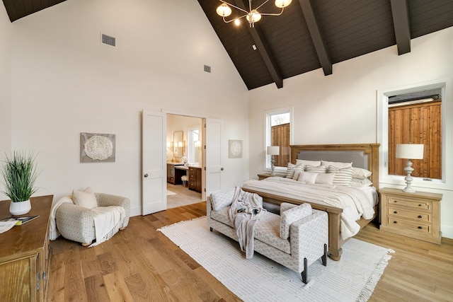 bedroom with connected bathroom, high vaulted ceiling, hardwood / wood-style flooring, wooden ceiling, and an inviting chandelier