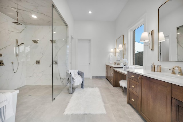 bathroom featuring tiled shower and vanity