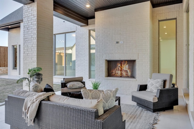 view of patio / terrace featuring an outdoor brick fireplace