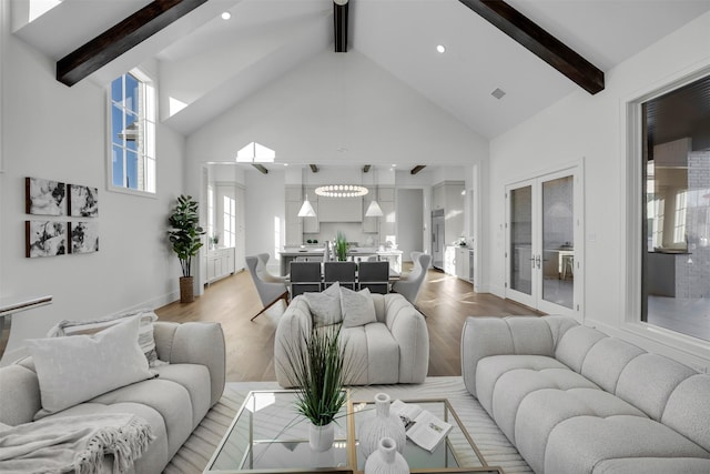 living room featuring wood-type flooring, high vaulted ceiling, and beam ceiling