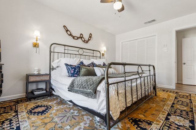 bedroom featuring a ceiling fan, visible vents, and baseboards