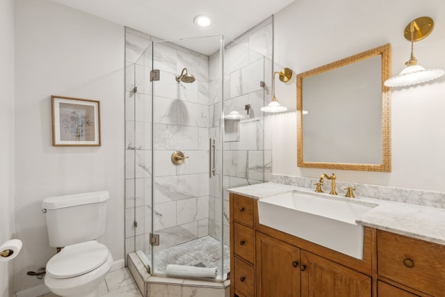 bathroom featuring marble finish floor, recessed lighting, toilet, a stall shower, and vanity