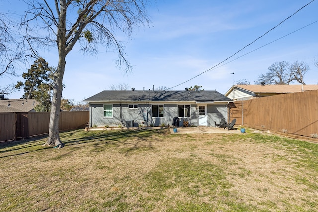 back of house featuring a yard and a patio