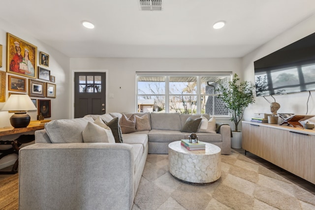 living area featuring visible vents and recessed lighting