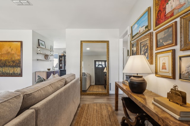 living area featuring visible vents and dark wood finished floors