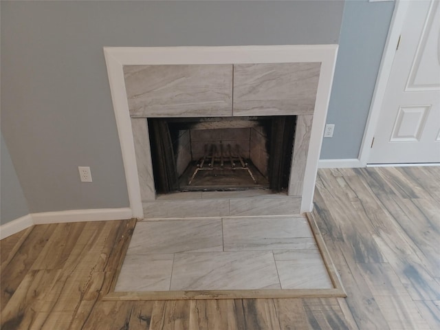 interior details with hardwood / wood-style flooring and a premium fireplace