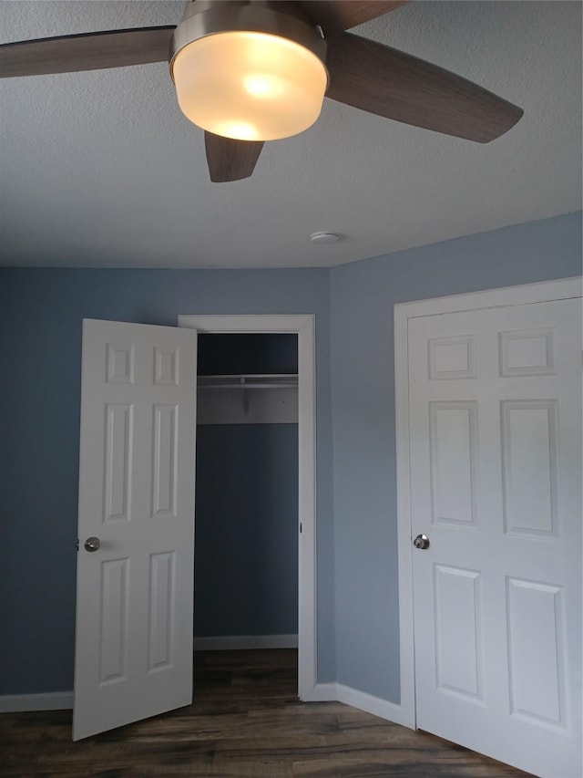 unfurnished bedroom featuring dark hardwood / wood-style flooring and a closet