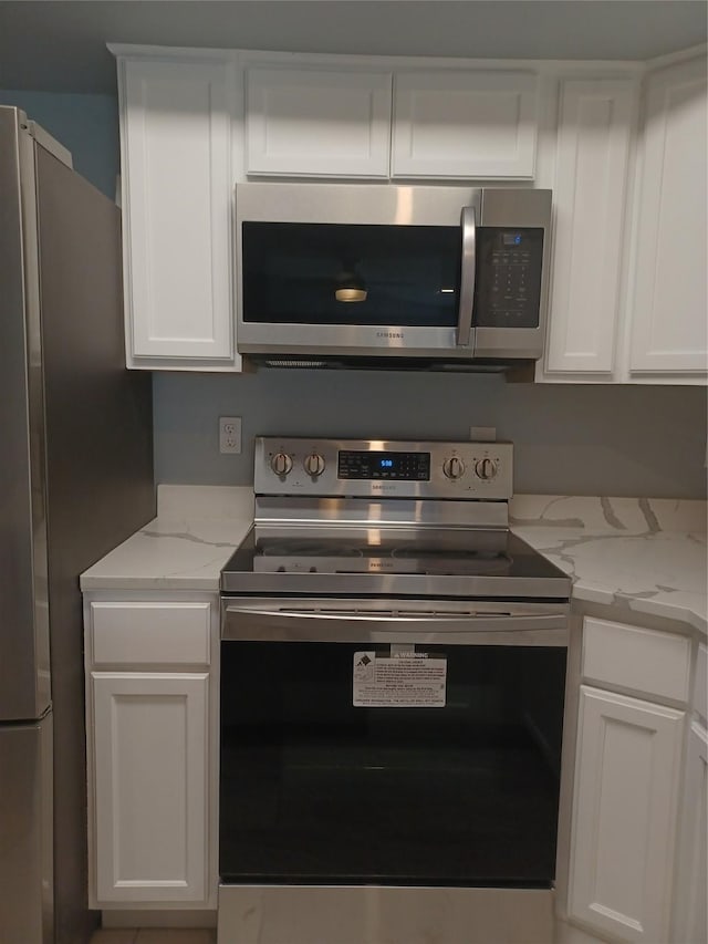 kitchen with white cabinetry and stainless steel appliances