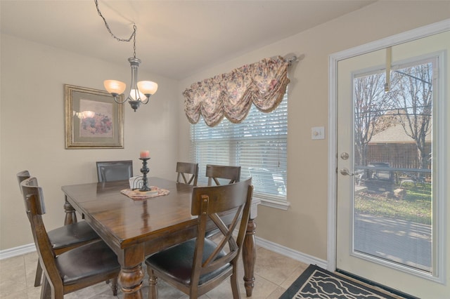 tiled dining space featuring a notable chandelier