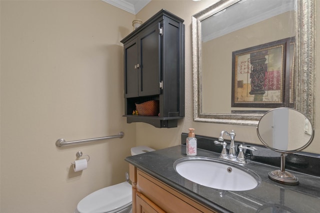 bathroom featuring vanity, ornamental molding, and toilet