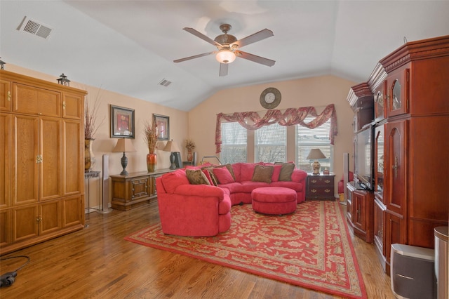 living room with ceiling fan, lofted ceiling, and light wood-type flooring