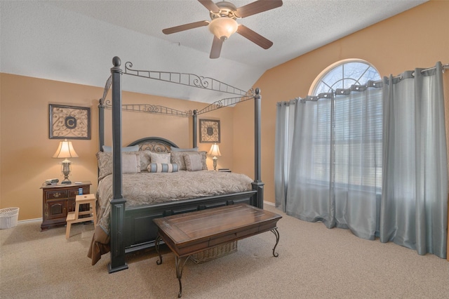 carpeted bedroom featuring ceiling fan, lofted ceiling, and a textured ceiling