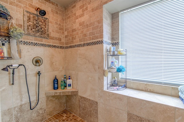 bathroom with a tile shower